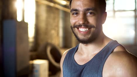 Handsome-Sweaty-Muscular-Man-Smiles-on-Camera.