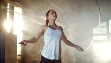 Athletic-Beautiful-Woman-Exercises-with-Jump-/-Skipping-Rope-in-a-Gym.-She's-Doing-Part-of-Her-Intense-Fitness-Training.