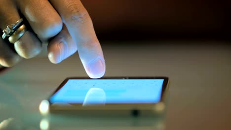 Close-up-of-a-female-hand-writing-a-message-to-her-friends-on-a-smart-phone.