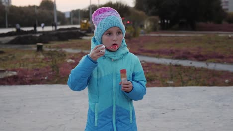 One-very-serious-young-girl-is-standing-on-the-street-in-the-autumn-evening.