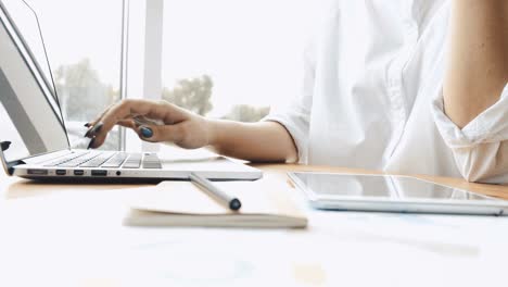 Woman-using-laptop-and-tablet