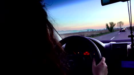 Successful-businesswoman-driving-on-road,-pov