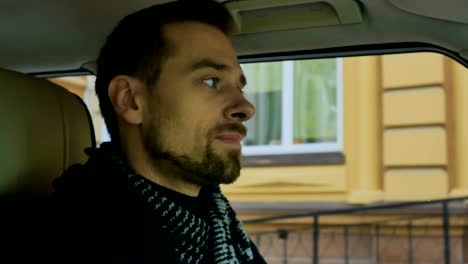 Man-drives-the-car-and-sniff-the-scarf-after-a-date-with-girlfriend