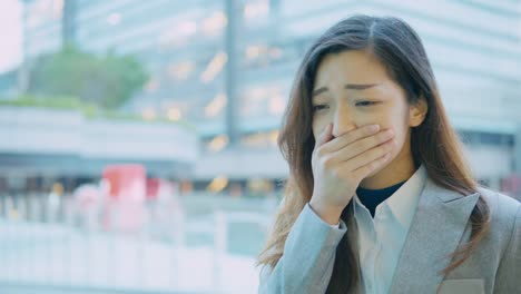 business-woman-coughing-and-sneezing-at-outdoor-in-the-city