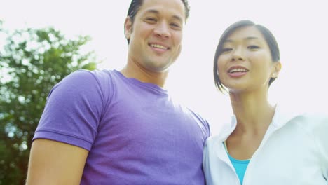 Young-male-female-ethnic-couple-laughing-together-outdoors