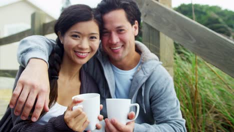 Portrait-Ethnic-Male-Female-Keeping-Warm-Outdoors-Beach