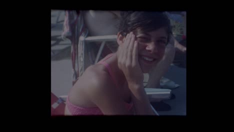 1960's-Portrait-shots-of-pretty-girl-and-family-sitting-around-pool