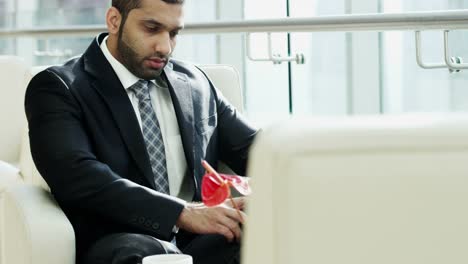 Portrait-male-Middle-Eastern-businessman-using-wireless-tablet
