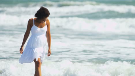 Portrait-of-attractive-woman-enjoying-waves-on-beach