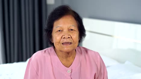 senior-woman-drinking-water-in-the-bedroom