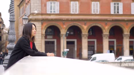 Thoughtful-sad-lonely-chinese-woman-contemplating-the-city