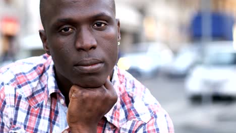 Pensive-young-black-african-man-looking-at-camera,-close-up