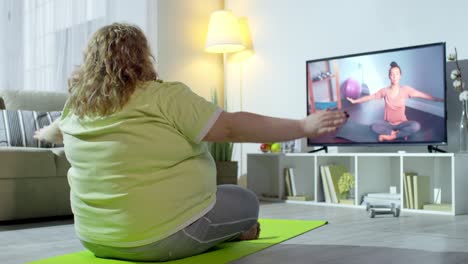 Plus-Size-Woman-Doing-Yoga-with-Online-Instructor