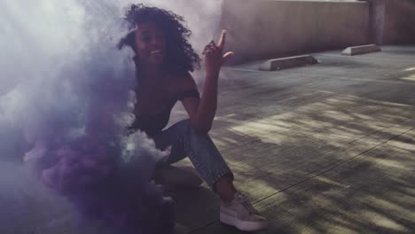 Beautiful-young-woman-modeling-with-purple-smoke-grenade-in-dramatic-moody-lighting