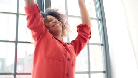 Portrait-of-happy-cheerful-young-afro-american-woman-at-home.