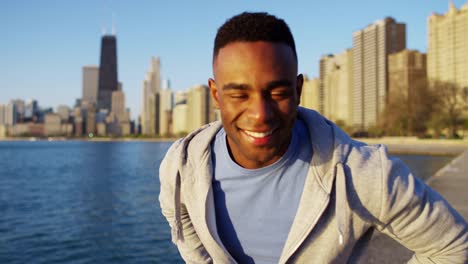 Portrait-of-Ethnic-male-stretching-outdoors-in-city