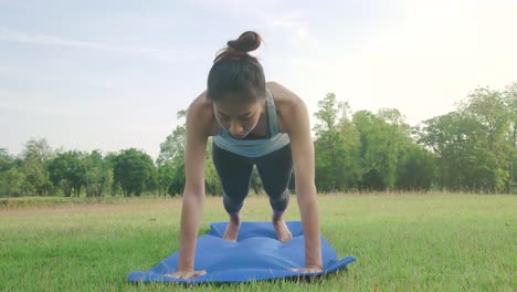 Junge-asiatische-Frau-Yoga-im-Freien-bleiben-Sie-ruhig-und-meditiert-beim-Üben-von-Yoga,-die-innere-Ruhe-zu-erkunden.-Yoga-und-Meditation-haben-gute-Vorteile-für-die-Gesundheit.-Yoga-Sport-und-gesunde-Lifestyle-Konzept.