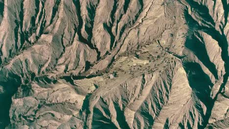 Horses-carrying-tourist-up-the-half-point-to-Mount-Bromo-crater-an-aerial-view,-Indonesia