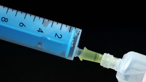 Plastic-medical-syringe-with-needle-and-plastic-vial.-Medical-injection-concept.-Medical-equipment.-4k-resolution.