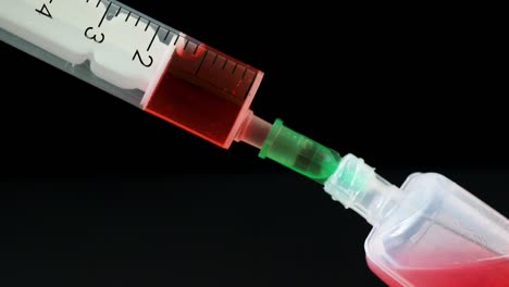 Plastic-medical-syringe-with-needle-and-plastic-vial.-Medical-injection-concept.-Medical-equipment.-4k-resolution.