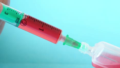 Plastic-medical-syringe-with-needle-and-plastic-vial.-Medical-injection-concept.-Medical-equipment.-4k-resolution.