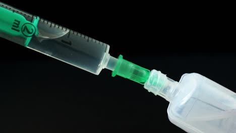 Plastic-medical-syringe-with-needle-and-plastic-vial.-Medical-injection-concept.-Medical-equipment.-4k-resolution.