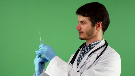 Handsome-male-doctor-preparing-syringe-with-vaccine