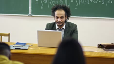 Male-University-Teacher-Using-Laptop-Computer