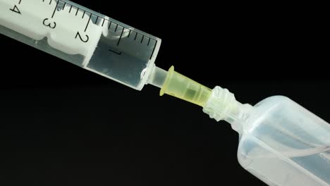 Plastic-medical-syringe-with-needle-and-plastic-vial.-Medical-injection-concept.-Medical-equipment.-4k-resolution.