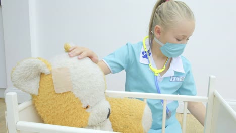 Girl-nursing-her-teddy-bear