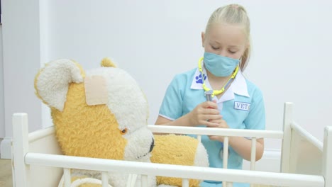 Girl-nursing-her-teddy-bear