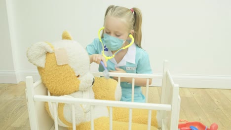 Girl-nursing-her-teddy-bear