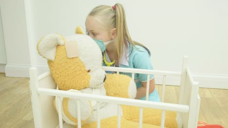 Girl-nursing-her-teddy-bear