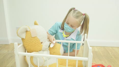 Girl-nursing-her-teddy-bear