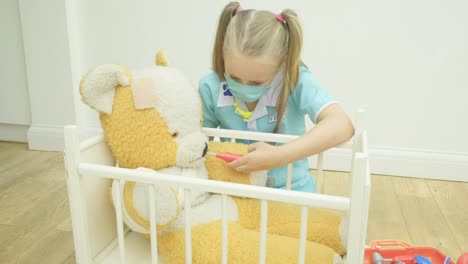 Girl-nursing-her-teddy-bear