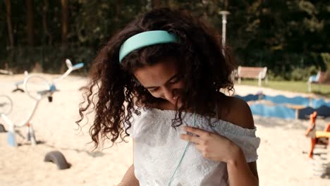 Happy-young-afro-american-woman-with-headphones-enjoying-music-and-her-vacation.