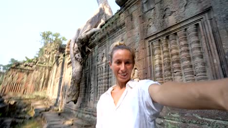 Travel-female-taking-selfie-portrait-at-ancient-temple