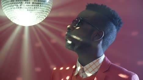 Stylish-Black-Man-Looking-at-Disco-Ball