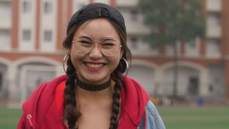 Asian-college-girl-smile-at-camera-in-campus-slow-motion