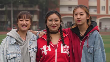 Three-happy-asian-college-girl-smile-at-camera