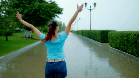 Happy-woman-jumping-in-the-rain