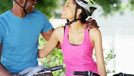 Portrait-fit-ethnic-male-female-bicycle-riding-outdoors