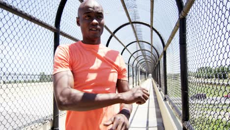 Young-active-ethnic-male-training-on-walkway-outdoor