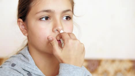 Teen-girl-sprays-into-the-nose-spray