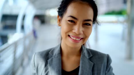 Young-woman-standing-with-happiness-smile