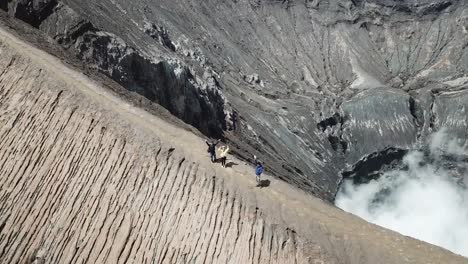 4K-Tracking-Couple-walking-by-drone-at-Crater-of-Mt.-Bromo