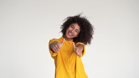 Cheerful-woman-giving-thumbs-up-gesture