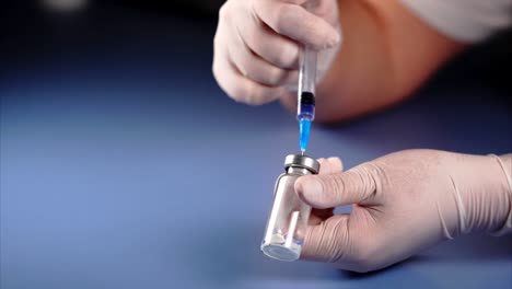 Mixing-of-medicine.-Doctor-piercing-the-lid-of-the-ampoule-with-syringe.