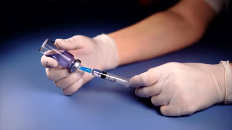 Filling-medicine-from-ampoule-into-syringe