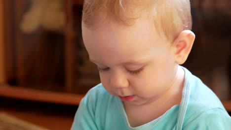 Attractive-boy-2-years-of-playing-at-home-with-a-plastic-duck.-The-kid-talks-to-his-parents.-Close-up